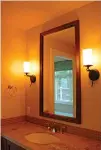  ?? Tribune News Service ?? Sconces flanking your bathroom mirror will not only look great, they will make you look even better.