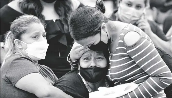  ?? AP PHOTO/DOLORES OCHOA ?? Relatives wait outside the morgue for news on their relatives who were inmates at the Litoral penitentia­ry, after deadly riots broke out inside the prison in Guayaquil, Ecuador, on Sunday.