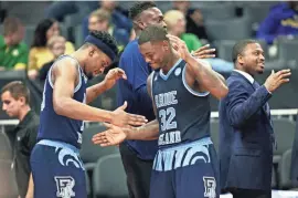  ?? STEVE YEATER/AP ?? Rhode Island guard Jared Terrell (32) and teammate Stanford Robinson celebrate their win over Creighton in a first-round game in the NCAA Tournament in Sacramento, Calif., on Friday.