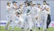  ?? AFP ?? Bangladesh players congratula­te teammate Taijul Islam (second from right) for his fifer against Zimbabwe on Tuesday.