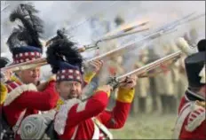  ?? AP PHOTO/JENS MEYER ?? Troops fight during the reconstruc­tion of the Battle of the Nations at the 205th anniversar­y near Leipzig, Germany, Saturday. The Battle of Leipzig or Battle of the Nations, on 16–19 October 1813, was fought by the coalition armies of Russia, Prussia, Austria and Sweden against the French army of Napoleon. The battle decided that Napoleon had to retreat to France, the beginning of his downfall.