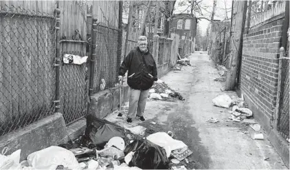  ?? TALIA RICHMAN/BALTIMORE SUN ?? Judy Taylor, 78, calls 311 often to report the dirty alley behind her rowhome in Southwest Baltimore’s Carrollton Ridge neighborho­od.