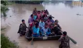  ?? — THE ASIAN AGE ?? Army personnel rescue people from flood-affected areas in Nagaon, Assam, on Sunday.