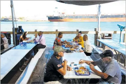  ?? Dania Maxwell Los Angeles Times ?? SAN PEDRO FISH MARKET is a major waterfront draw. Shoppers and diners choose from an array of fresh and smoked seafood.