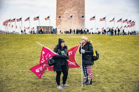  ?? SAMUEL CORUM/GETTY ?? Supporters of then-President Donald Trump gather on the lawn around the base of the Washington Monument on Jan. 6. A riot later in the day at the U.S. Capitol would leave five people dead.