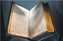  ?? Kent Nishimura Los Angeles Times ?? THE BIBLE, shown at the National Museum of African American History and Culture, was confirmed by a Smithsonia­n curator to have been printed in 1869.