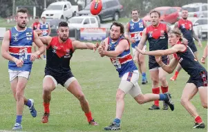  ??  ?? Bunyip’s Shane Smith handballs under pressure.