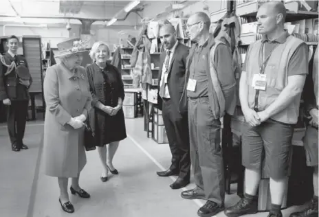  ?? CHRIS JACKSON/AFP/GETTY IMAGES ?? Queen Elizabeth tours the Royal Mail Windsor postal delivery office on Wednesday. The Queen is set to go on a royal walkabout around Windsor.
