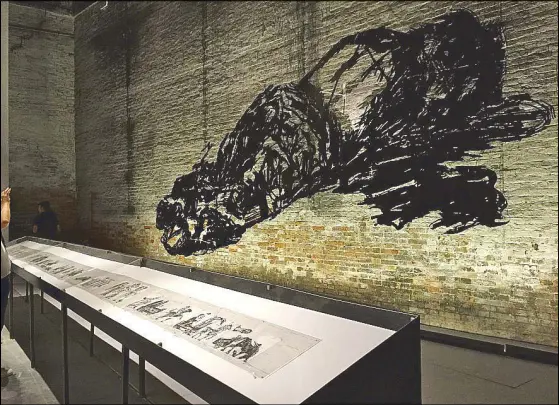  ??  ?? “We are all in danger”: William Kentridge’s “Omaggio All’Italia (Tribute to Italy)” looms large at the Italian pavilion.