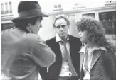  ?? THE ASSOCIATED PRESS ?? Feb. 11, 1973: Bertolucci, left, discusses a scene with actor Marlon Brando, centre, and actress Maria Schneider on the set of “Last Tango in Paris,” in Paris.