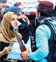  ?? ?? PROTEST: Women confront armed Taliban fighters in Kabul