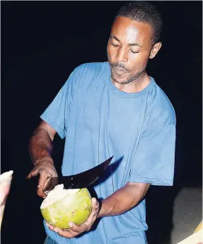  ??  ?? Jelly coconut, anyone? Orlando Wallace was on hand to have it chopped and ready to enjoy.