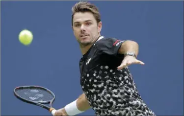  ?? SETH WENIG — ASSOCIATED PRESS ?? Stan Wawrinka returns a shot to Grigor Dimitrov during the first round of the U.S. Open in New York on Monday.