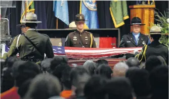  ?? Craig Kohlruss / Associated Press ?? Honor guard members prepare to fold an American flag before presenting it to the family of National Forest Service Capt. Brian Hughes during a memorial service at Valdez Hall in Fresno, Calif.