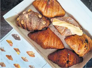  ?? KARON LIU TORONTO STAR ?? Hazukido has over 100 flavours in rotation. Among the 14 now at the Toronto shop are croissants filled with a custardy salted egg yolk, smeared with cod roe and topped with melted cheese.