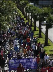  ?? AP PHOTO/ REBECCA BLACKWELL ?? Scores of Central American migrants, representi­ng the thousands participat­ing in a caravan trying to reach the U.S. border, undertake an hours-long march to the office of the United Nations’ humans rights body in Mexico City on Thursday.