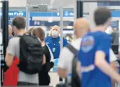  ?? JOHN J. KIM/CHICAGO TRIBUNE 2021 ?? Chicago is one of the least impacted cities in terms of airfare increases. Above, a TSA worker stands at Chicago O’Hare Internatio­nal Airport.