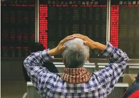  ?? AP ?? ■ An investor reacts to stock market prices in Beijing yesterday. Asian stock prices skidded following the arrest of the Huawei CFO that could derail progress in China-US trade talks.