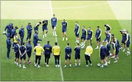  ?? MIKE EGERTON — PA VIA AP ?? Ukraine players form a circle during a training session at the Cardiff City Stadium, Cardiff, Wales on Saturday the day before the team play Wales in a World Cup play-off soccer match.