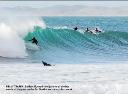  ??  ?? HEAVY TRAFFIC: Surfers flocked to enjoy one of the best swells of the year on the Far North’s west coast last week.