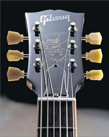  ?? Neil Godwin Guitarist Magazine via Getty Images ?? A HEADSTOCK with a Slash graphic on a Gibson USA Slash Les Paul Standard electric guitar, one of Gibson’s many models.