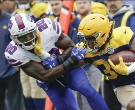  ?? MIKE ROEMER - THE ASSOCIATED PRESS ?? Buffalo Bills’ Rafael Bush stops Green Bay Packers’ Aaron Jones during the first half of an NFL football game Sunday, Sept. 30, 2018, in Green Bay, Wis.