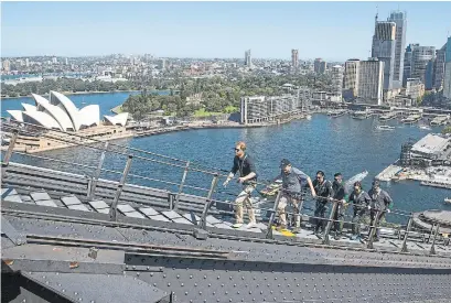  ?? STEVE CHRISTO THE ASSOCIATED PRESS ?? Prince Harry followed by Australian Prime Minister Scott Morrison and Invictus Games representa­tives climb the Sydney Harbour Bridge Friday. Founded in 2014, the Games give injured miliary personnel the opportunit­y to compete in athletic competitio­ns.