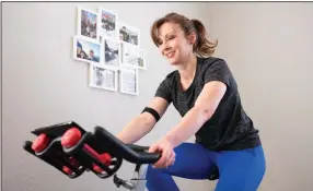  ?? (The New York Times/Max Whittaker) ?? Lisa Whitney built her own version of a Peloton bike using a secondhand exercise bike and some accessorie­s.