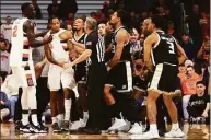  ?? Bryan M. Bennett / Getty Images ?? Syracuse and Bryant players react during a scuffle during the first half on Saturday.
