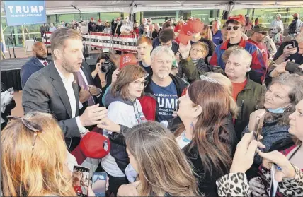  ?? Photos by Christophe­r Millette / Erie Times-news via AP ?? Eric Trump, left, greets well-wishers following a rally on Monday in support of his father, President Donald Trump, under a tent outside the Bayfront Convention Center in Erie, Pennsylvan­ia.