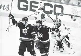  ?? GETTY IMAGES FILE PHOTO ?? Goalie Marc-Andre Fleury of the Vegas Golden Knights reacts as Mark Scheifele, left, is congratula­ted by teammate Paul Stastny of the Jets after scoring a second-period goal in Game 1.