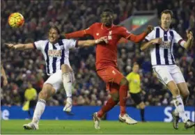  ?? JON SUPER — THE ASSOCIATED PRESS FILE ?? A Sunday file photo showing Liverpool’s Christian Benteke, centre, fighting for the ball against West Bromwich Albion’s Jonas Olsson, left, and Jonny Evans during the English Premier League soccer match between Liverpool and West Bromwich Albion. One...