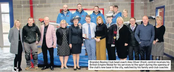  ??  ?? Brandon Boxing Club head coach Alex Oliver (front, centre) receives his British Empire Medal for his services to the sport during the opening of the club’s new base in the city, watched by his family and club coaches
