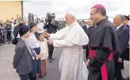  ?? PAULO CUNHA/ASSOCIATED PRESS ?? Pope Francis is greeted by three children dressed as shepherds as he arrives at Monte Real Air Base in Leiria, Portugal on Friday.