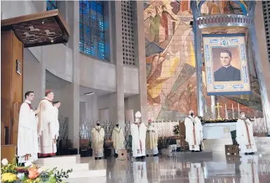  ??  ?? Michael McGivney, a Waterbury native and Knights of Columbus founder, was beatified Saturday at a ceremony at the Cathedral of St. Joseph in Hartford. A tapestry featuring McGivney’s portrait, top right, was unveiled in the sanctuary.