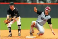  ??  ?? left Texarkana Razorbacks’ Parker Ripple slides into second base during the top of the seventh inning against the Bryant Black Sox in Conway, Ark.