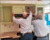  ?? DONNA ROVINS — DIGITAL FIRST MEDIA ?? Longacre Co. employees install the company’s display at the NARIBIE Family and Home Expo. The annual event is scheduled for March 3 and 4 at the Coventry Mall.