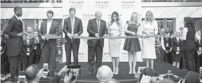  ?? JABIN BOTSFORD/THE WASHINGTON POST ?? The Trump family cuts the ribbon during the opening ceremony of the Trump Internatio­nal Hotel in Washington, D.C.