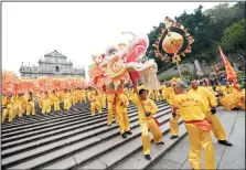  ?? CHEONG KAM KA/XINHUA/ZUMA PRESS ?? People perform the dragon dance to celebrate the Year of Sheep in Macao, south China, on Thursday, Feb. 19, 2015, the first day of Chinese lunar new year.