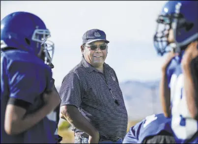  ??  ?? Football coach Richard Egan leads practice Sept. 25 at McDermitt Combined School. Egan played on the team when it won the state championsh­ip in 1982.