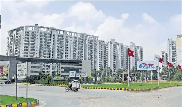  ?? HT FILE ?? A housing project in Gurgaon. The common areas in a housing project are the spaces shared by the allottees and used for different purposes; and (below) a view of a living room in an apartment.