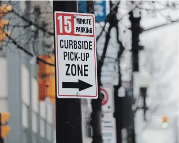  ?? MATTHEW P. BARKER EXAMINER ?? Curbside pickup areas have been created throughout the downtown core for people to use for free for about 15 minutes to do quick drop offs or pickups. Signs adorn the area to signify where people can park for quick service from businesses.