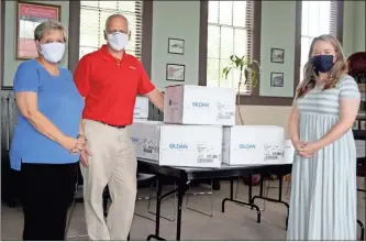  ?? Jeremy Stewart ?? Gildan Cedartown Human Resources Manager Susan Oswalt (from left) and Plant Manager Gregg Webb delivered 3,800 face masks to Polk County Chamber of Commerce Executive Director Blair Elrod in August to distribute to Polk County elementary school students.