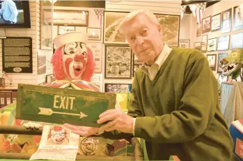  ?? BOB RUEGSEGGER/FREELANCE PHOTOS ?? Museum director Charles Fleetwood holds a recently donated artifact from the Ocean View Amusement Park. The sign once marked the roller coaster exit.