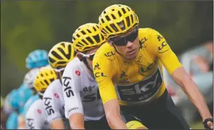  ?? The Associated Press ?? HOT PURSUIT: Britain’s Chris Froome, wearing the overall leader’s yellow jersey, rides in the pack in chase of a breakaway group of four riders during the seventh stage of the Tour de France, a 132.7mile leg Friday ending in Nuits-Saint-Georges, France.