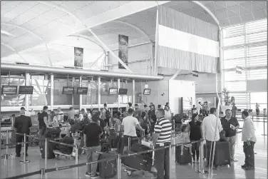  ?? AP/BRAM JANSSEN ?? Travelers line up to check in Wednesday at the Irbil Internatio­nal Airport in Iraq. Iraq’s prime minister ordered the country’s Kurdish region to hand over control of its airports to federal authoritie­s or face a flight ban, a response to the Kurdish...