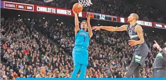  ?? — AFP ?? PARIS: Malik Monk #1 of the Charlotte Hornets drives to the basket against the Milwaukee Bucks as part of NBA Paris Games 2020 in Paris, France at the AccorHotel­s Arena.