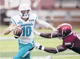  ?? VASHA HUNT/AP ?? Coastal Carolina QB Grayson McCall tries to escape a tackle during Saturday’s victory over Troy. The Chanticlee­rs finished the regular season 11-0.