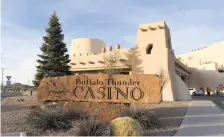  ?? NEW MEXICAN FILE PHOTO ?? Buffalo Thunder Resort & Casino on Pojoaque Pueblo. Four companies that provided slot machines to the pueblo while it was operating casinos in violation of federal law have settled with the state Gaming Control Board, which had threatened not to renew...