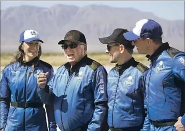  ?? LM Otero Associated Press ?? WILLIAM SHATNER, second from left, talks about his Blue Origin spacefligh­t flanked by fellow crew members Audrey Powers, Chris Boshuizen and Glen de Vries. Their journey to suborbital space lasted 10 minutes.